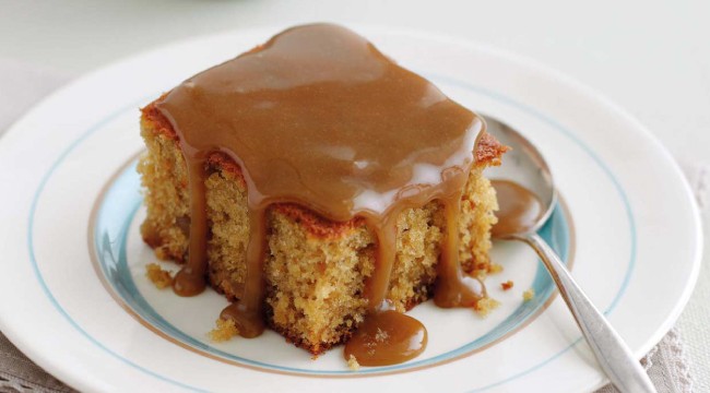 Sticky Cake with sauce on a plate with spoon