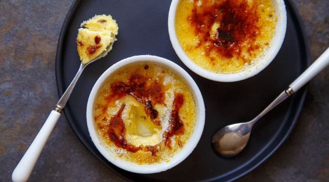two creme brulees with spoons